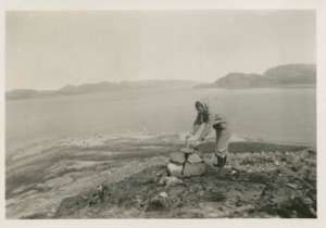 Image: Miriam MacMillan examining rock cairn on shore
